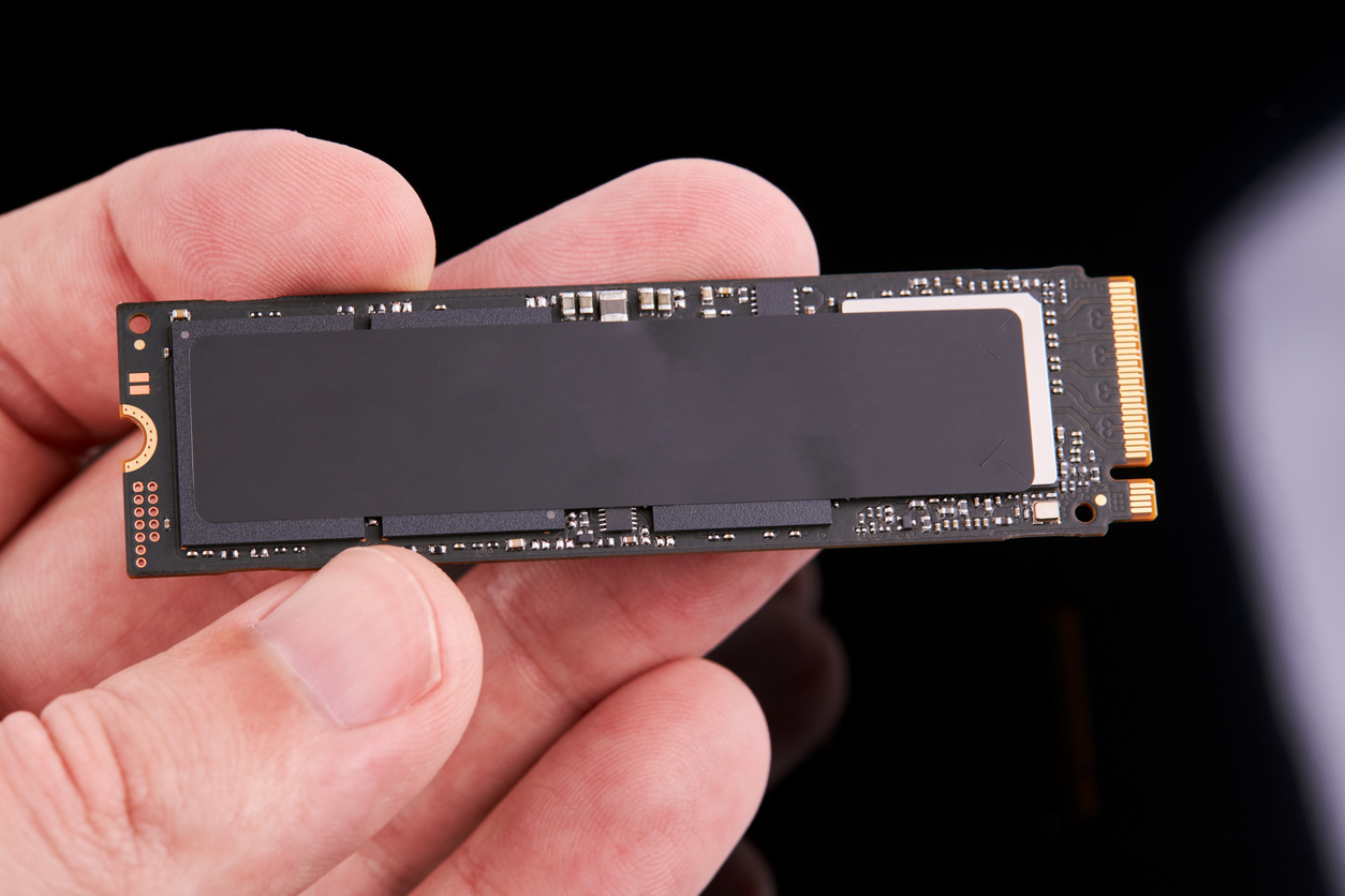 Engineer holding an M.2 NAND solid-state drive.