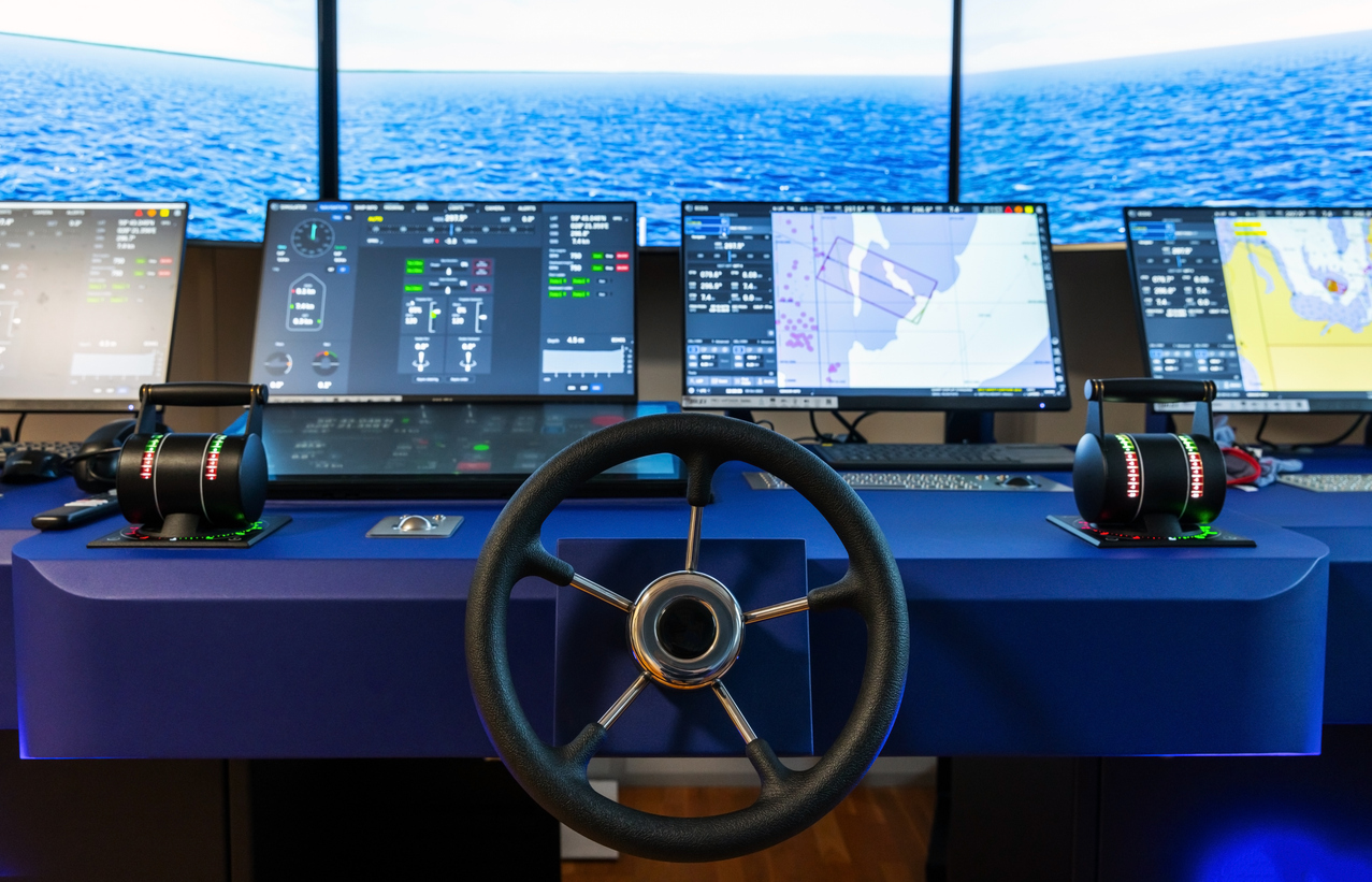 Captain’s bridge with modern ship control panel, steering wheel, and engine accelerators.