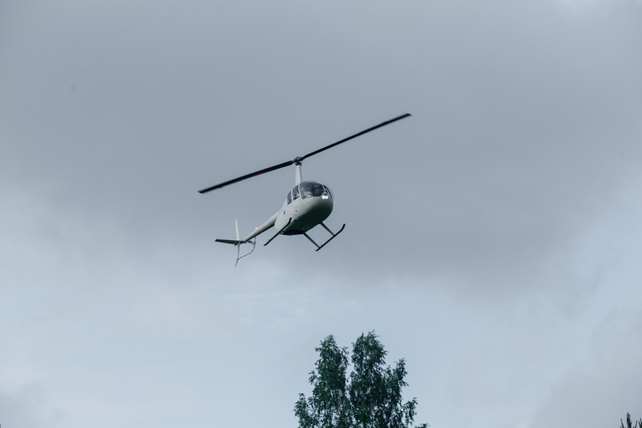 Small helicopter in flight. Helicopter for two people concept.