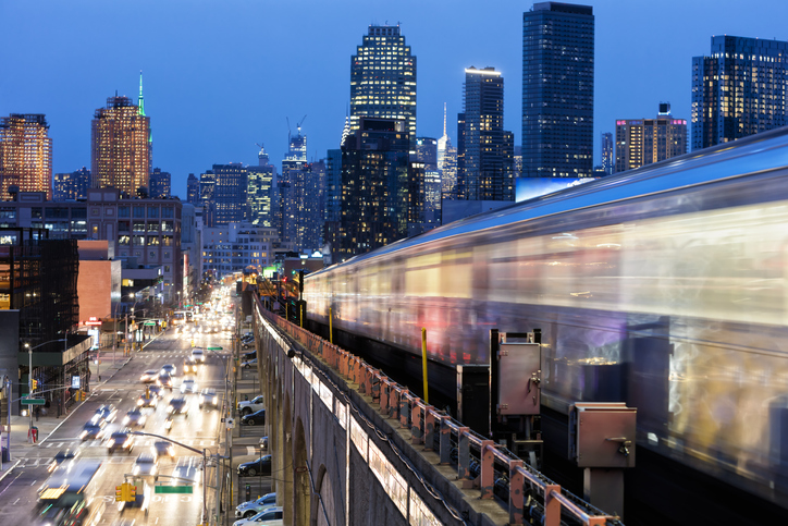 A speeding train on a bridge over traffic in New York City