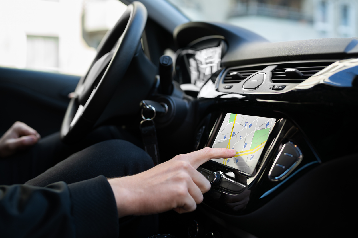 Car GPS system displaying navigation and tracking maps.