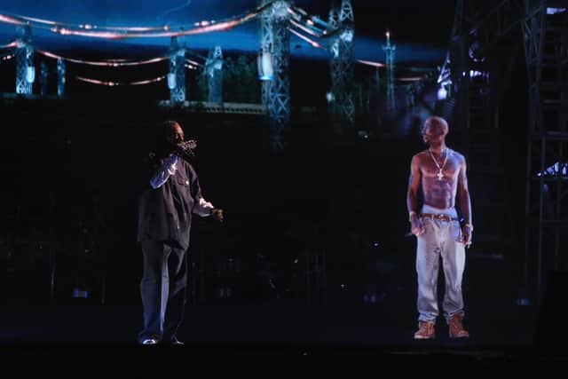 A  holographic generation of Tupac Shakur on a stage.