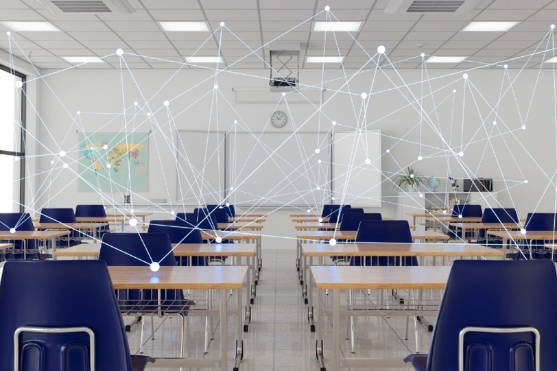 Empty classroom with desks and chairs showing a connected smart classroom.