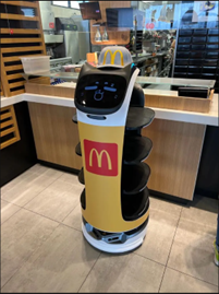 McDonald's robotic assistant with display of a cartoon-like face. 